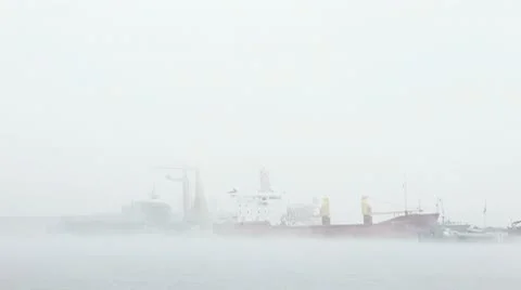 Harbor in mist unloading ship and moving cranes part 2 動画素材 9655480