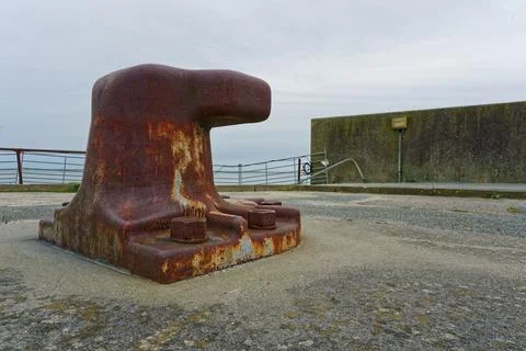Harbor mooring hook bollard for securing ship lines. Stock Photos