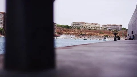 Harbor pier view toward mediterranean coastal resort town, marina and boats Stock Footage 341578513