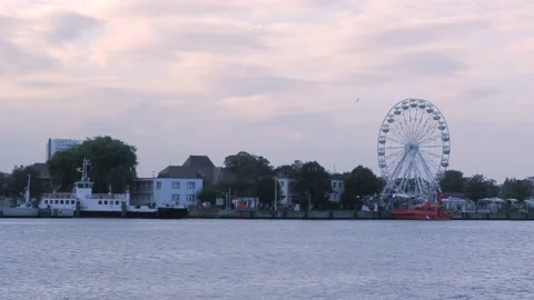Harbor Rostock in autumn at sunset - rotating giant wheel - passenger ship Stock Footage 140397341
