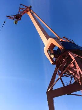 Harbour crane on the dock Stock Photos