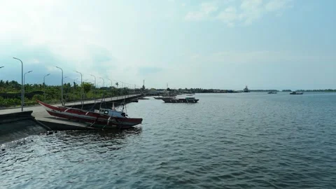 Harbour scene features red boats docked at the pier. 스톡 동영상 335588159