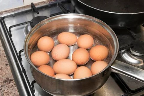 Hard boiled brown eggs in a metal saucepan Stock Photos