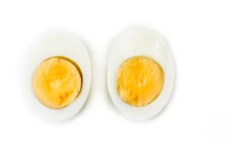 Hard boiled egg cut in halves on the white Stock Photos
