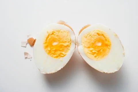 Hard-boiled egg with shell, halved Stock Photos