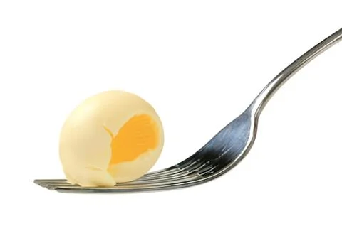 Hard boiled egg with spoon on plate Stock Photos