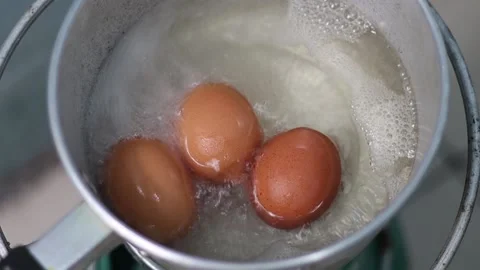 Hard-boiled eggs in hot boiling water are cooked in a pan. Stock-Footage 174037659