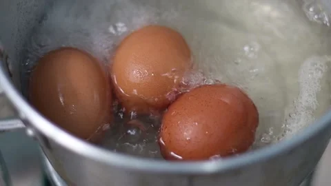 Hard-boiled eggs in hot boiling water are cooked in a pan. Stock-Footage 174037660