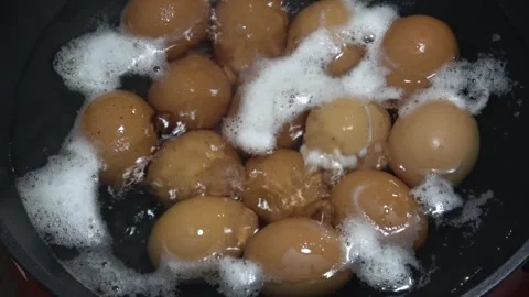 Hard boiling eggs in hot pot. Bubbling hot water. Video stock 312931504