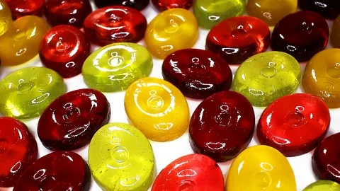 Hard candy candies closeup texture rotating video background Stock Footage 113143525
