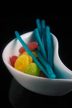 Hard candy in different shapes and colors isolated over black Stock Photos