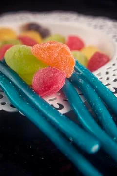 Hard candy in different shapes and colors isolated over black Stock Photos