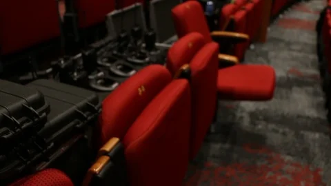 Hard carry cases, event mics, theatre seats setup for event Stock Footage 98684776