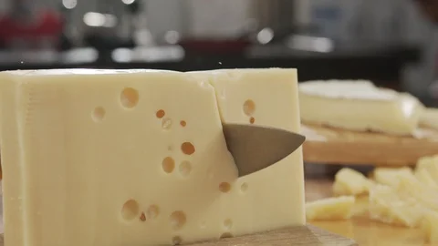 Hard Cheese cut with sharp knife on wooden board in slow motion Stock Footage 120402664