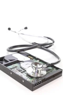 Hard disc with stethoscope on white background Fotos de archivo