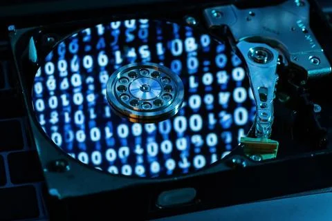 A hard disk with an abstract reflection of the binary code Foto stock
