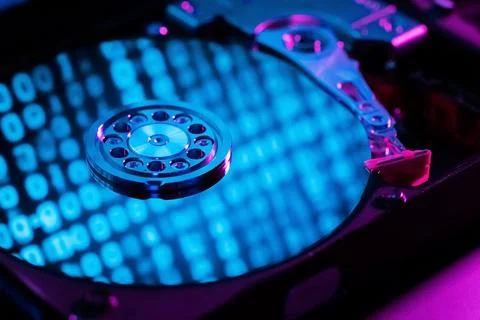 A hard disk with an abstract reflection of the binary code Stock Photos