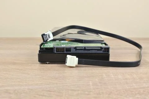 Hard disk and cable on a desk Stock Photos