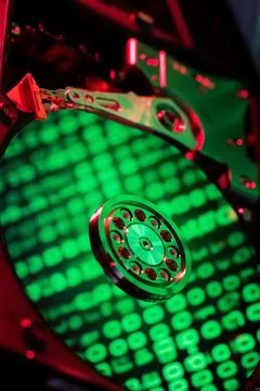 On the hard disk, the binary code is displayed in green numbers Stock Photos