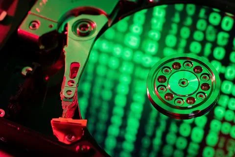On the hard disk, the binary code is displayed in green numbers Foto stock