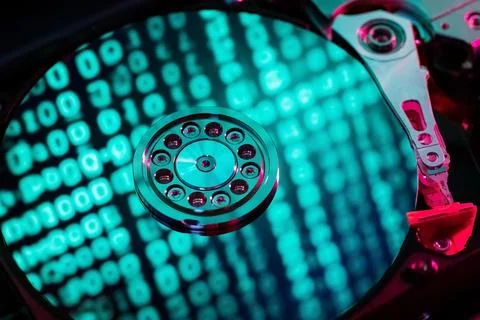 A hard disk with a blue binary code Stock Photos