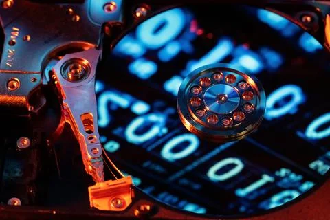 A hard disk with a blue binary code Stock Photos