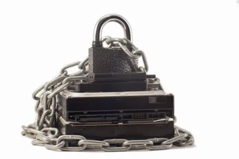 Hard disk, chain and padlock on a white background. The lock is locked. Stock Photos