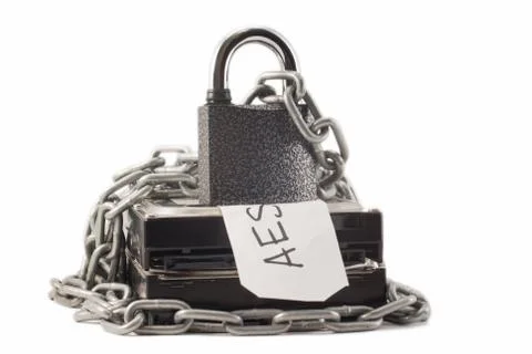Hard disk, chain and padlock on a white background. The lock is locked. Stock Photos