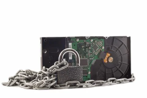 Hard disk, chain and padlock on a white background. The lock is locked. Stock Photos