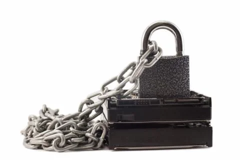 Hard disk, chain and padlock on a white background. The lock is locked. Stock Photos