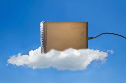 Hard disk on a cloud in the blue sky as a symbol for cloud storage Stock Photos