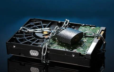 Hard disk drive on chain on dark blue background 스톡 사진