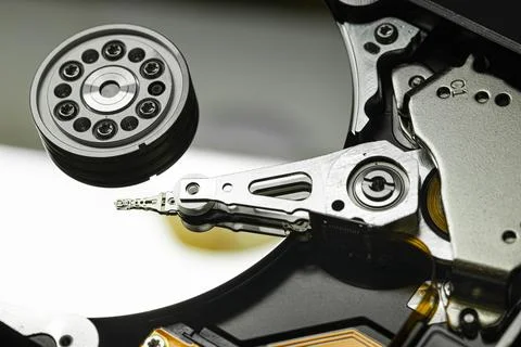 Hard disk drive closeup showing actuator arm reading data Stock Photos
