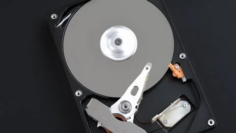 Hard disk drive inside with rotating platter and riding arm Stock Footage 261157570