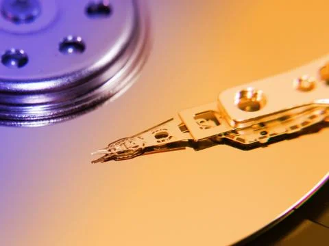 Hard disk drive inside, toned, closeup magnetic head and disk surface Stock Photos