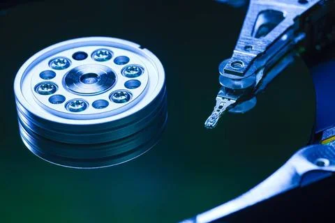  Hard disk drive reading data with blue light reflecting on its surface Cl... Stock Photos