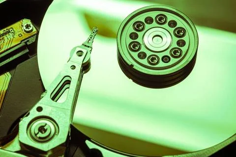  Hard disk drive reading data with green light, close-up view of magnetic ... 写真素材