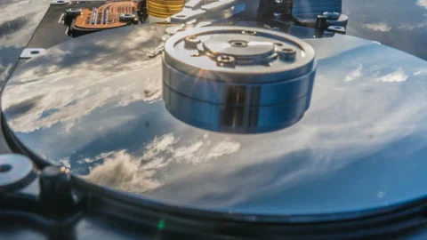 Hard disk drive with reflected in it the time-lapse of clouds, the concept of Stock Footage 96672703