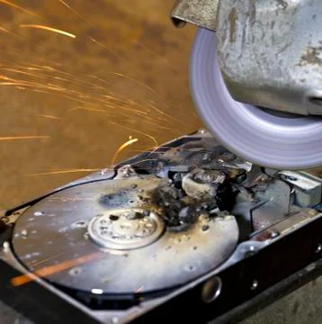 Hard disk driveand angle grinder Stock Photos