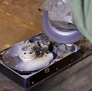 Hard disk driveand angle grinder detail shot of a massive destroyed hard d... Stock Photos