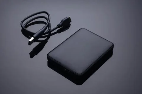 Hard disk external with wire on black background Stock Photos