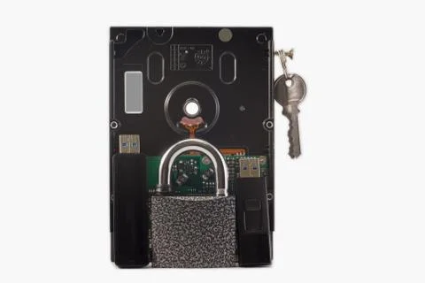 Hard disk, keys and padlock on a white background. The lock is locked. Stock Photos