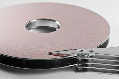 Hard disk platter and actuator arm detail shot of a separated hard disk pl... Stock Photos