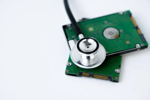 An hard disk with a stethoscope isolated on white background. Stock Photos