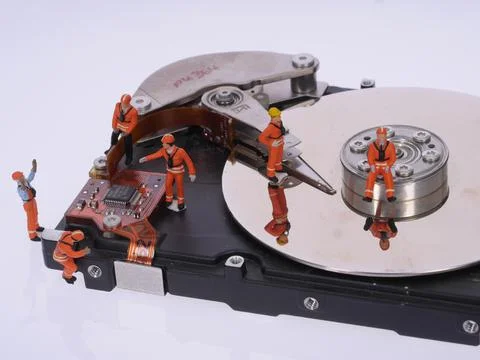 Hard disk with tiny humans Stock Photos