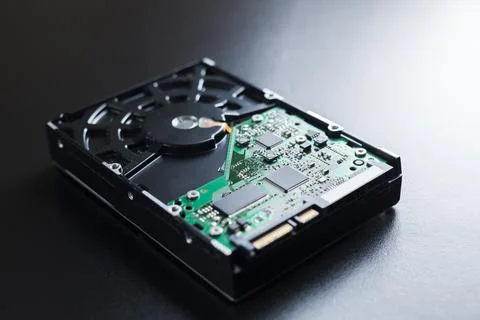 Hard disk on top of a table with its components and connections visible. Tech Photos