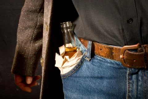 Hard drinker hiddes a bottle Stock Photos