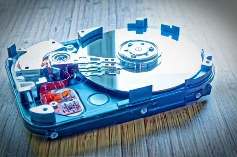 Hard drive 3.5 inches as a data storage with motherboard on a bamboo table Stock Photos