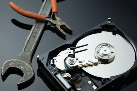 Hard drive from the computer hdd with mirror effect. And repair tools. Stock Photos