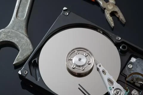 Hard drive from the computer hdd with mirror effect. And repair tools. Stock Photos